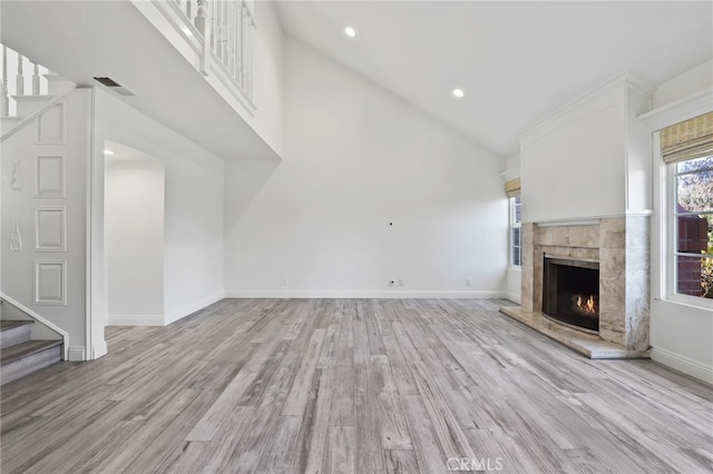 2720 Hilltop Dr Unit 58, Newport Beach, CA 92660 - unfurnished living room featuring a fireplace, stairs, light wood finished floors, recessed lighting, and high vaulted ceiling