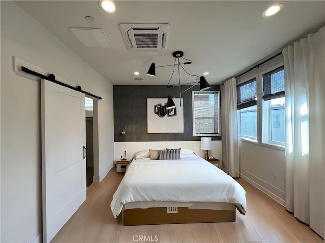 753 Site Dr, Brea, CA 92821 - bedroom featuring a barn door, light wood-style flooring, and recessed lighting
