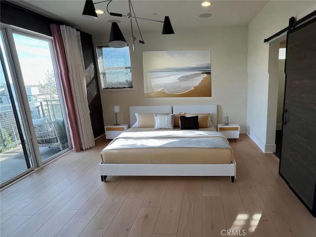 753 Site Dr, Brea, CA 92821 - bedroom with a barn door, access to outside, and wood finished floors