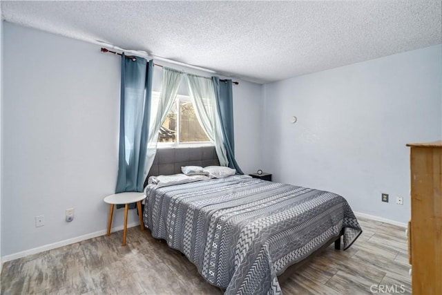 14811 Elizabeth Lake Rd, Lake Hughes, CA 93532 - bedroom with a textured ceiling and wood finished floors