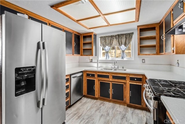 14811 Elizabeth Lake Rd, Lake Hughes, CA 93532 - kitchen featuring appliances with stainless steel finishes, light countertops, and glass insert cabinets