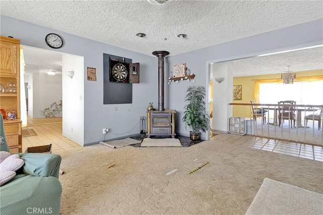 19428 Shasta Rd, Apple Valley, CA 92307 - living area with tile patterned floors, carpet flooring, a wood stove, and a textured ceiling