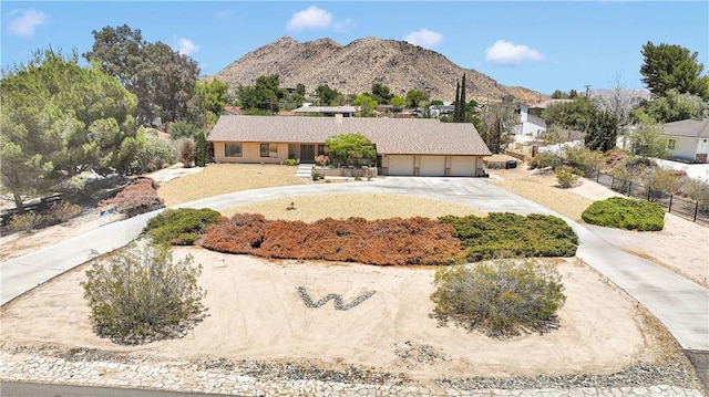 19428 Shasta Rd, Apple Valley, CA 92307 - view of front facade with a garage, curved driveway, and a mountain view