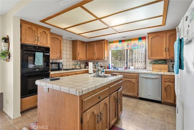 19428 Shasta Rd, Apple Valley, CA 92307 - kitchen featuring black appliances, brown cabinetry, a center island, decorative backsplash, and tile countertops