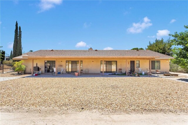 19428 Shasta Rd, Apple Valley, CA 92307 - rear view of property featuring stucco siding, a patio area, and a chimney