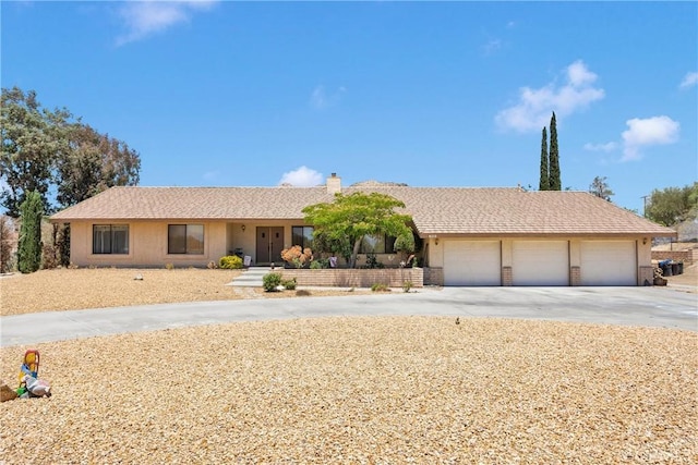 19428 Shasta Rd, Apple Valley, CA 92307 - ranch-style home with an attached garage, concrete driveway, and a chimney