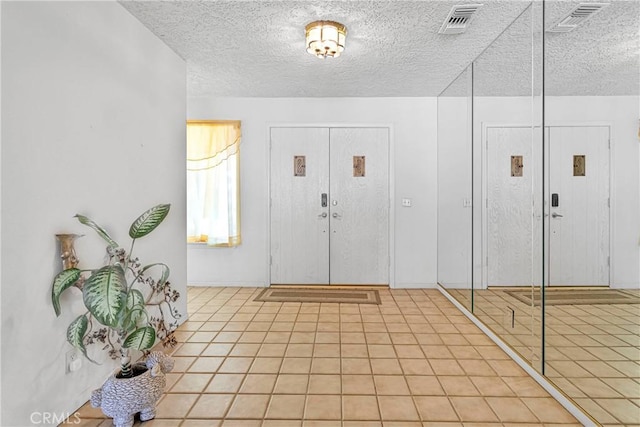 19428 Shasta Rd, Apple Valley, CA 92307 - entryway featuring a textured ceiling and light tile patterned flooring