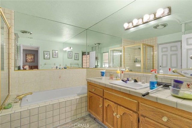 19428 Shasta Rd, Apple Valley, CA 92307 - bathroom with a garden tub, vanity, and a stall shower