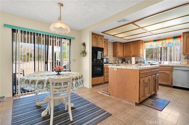 19428 Shasta Rd, Apple Valley, CA 92307 - kitchen featuring stainless steel dishwasher, tile countertops, tasteful backsplash, hanging light fixtures, and a kitchen island
