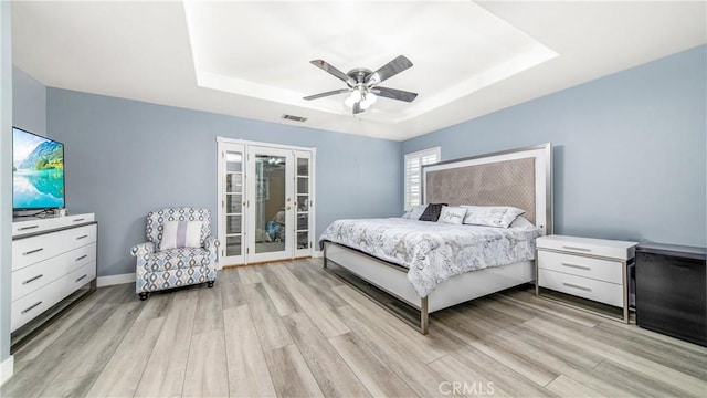 18223 Shannon Ridge Pl, Canyon Country, CA 91387 - bedroom with a raised ceiling, light wood-style flooring, french doors, and a ceiling fan