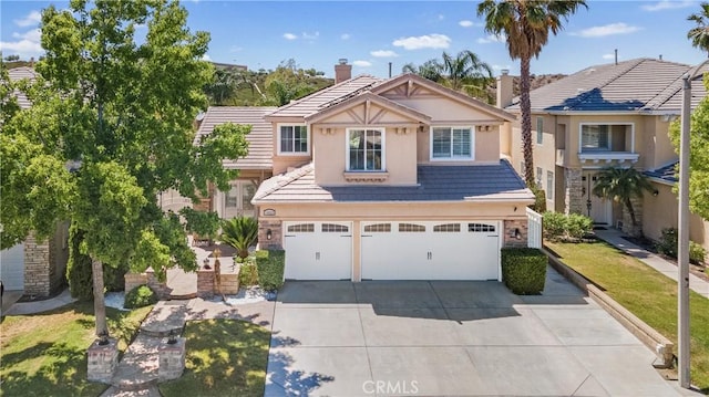 18223 Shannon Ridge Pl, Canyon Country, CA 91387 - view of front of house featuring concrete driveway, a garage, a tile roof, stucco siding, and a chimney