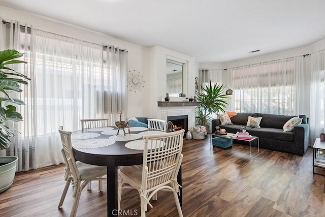 26853 Summer Sunshine Dr, Menifee, CA 92585 - dining area featuring wood finished floors and a fireplace