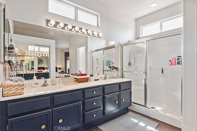 26853 Summer Sunshine Dr, Menifee, CA 92585 - bathroom with double vanity, a stall shower, and wood finished floors