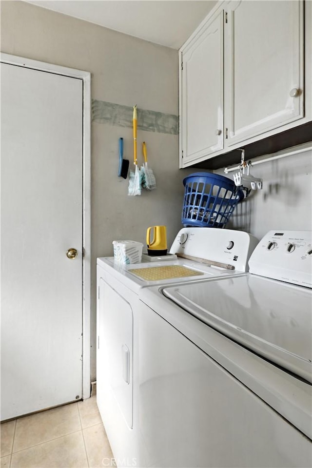 2997 June Ct, Merced, CA 95348 - washroom with washer and dryer, cabinet space, and light tile patterned floors