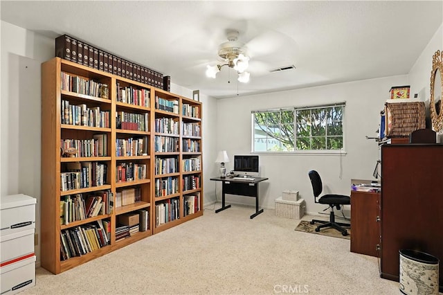 2997 June Ct, Merced, CA 95348 - carpeted office space featuring a ceiling fan and wall of books