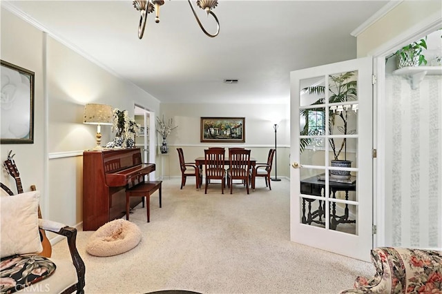 2997 June Ct, Merced, CA 95348 - dining space featuring light colored carpet, a chandelier, and ornamental molding