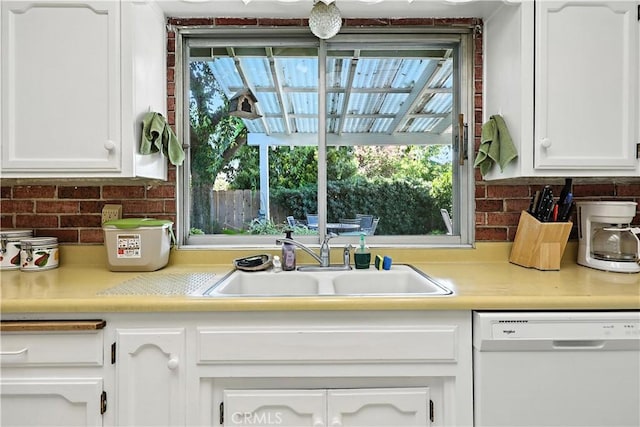 2997 June Ct, Merced, CA 95348 - kitchen with white dishwasher, white cabinetry, light countertops, and backsplash