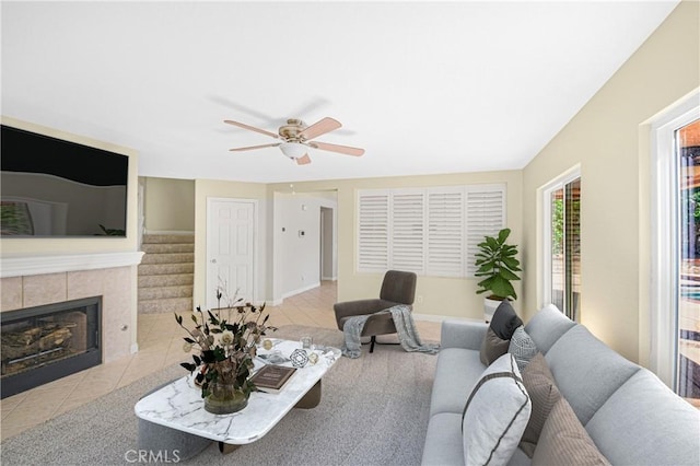 30526 Beryl Pl, Castaic, CA 91384 - living area featuring ceiling fan, a tiled fireplace, stairway, and tile patterned flooring