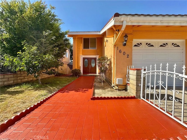 1602 Via Palermo, Montebello, CA 90640 - view of front of home featuring stucco siding and a garage