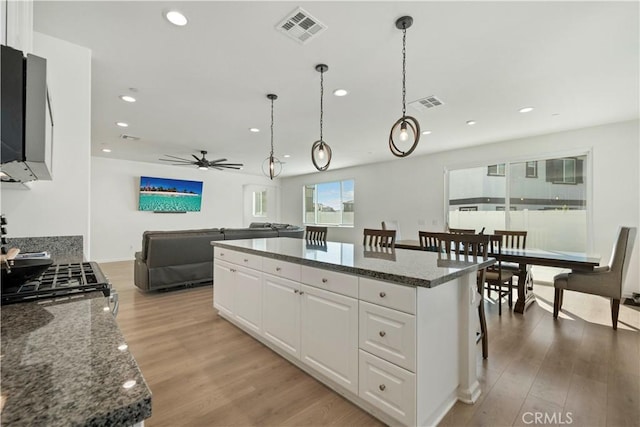 36300 Firelight Cir, Wildomar, CA 92595 - kitchen featuring ceiling fan, white cabinetry, a center island, light wood finished floors, and recessed lighting