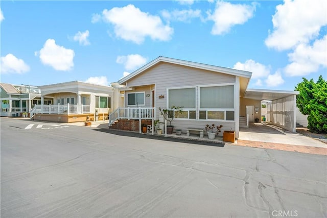 6536 Oceanview Dr Unit T, Carlsbad, CA 92011 - manufactured / mobile home with an attached carport and driveway