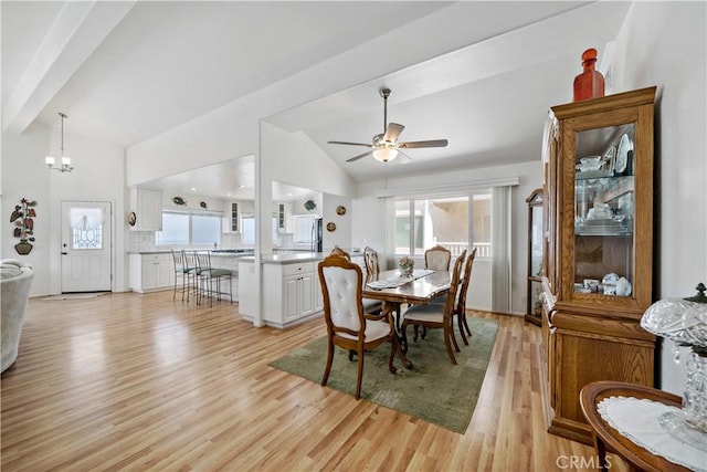 6536 Oceanview Dr Unit T, Carlsbad, CA 92011 - dining area featuring lofted ceiling, light wood-style floors, a ceiling fan, and a chandelier