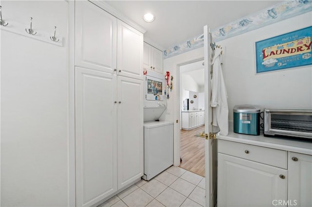 6536 Oceanview Dr Unit T, Carlsbad, CA 92011 - laundry area featuring stacked washing machine and dryer, light tile patterned floors, and recessed lighting