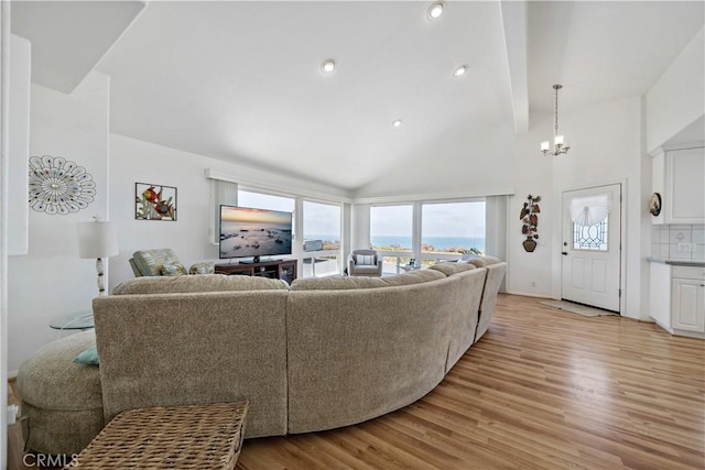 6536 Oceanview Dr Unit T, Carlsbad, CA 92011 - living room featuring plenty of natural light, light wood-type flooring, a chandelier, recessed lighting, and high vaulted ceiling