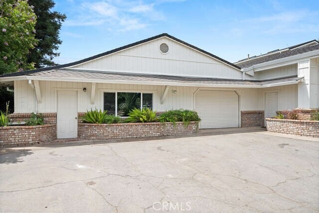 2915 Kennedy Ave Unit A & B, Chico, CA 95973 - view of front of home with brick siding, an attached garage, concrete driveway, and roof with shingles
