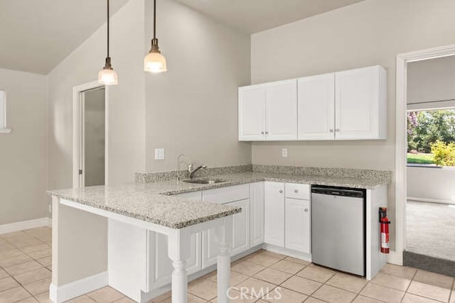 2915 Kennedy Ave Unit A & B, Chico, CA 95973 - kitchen featuring dishwasher, a peninsula, white cabinets, light tile patterned flooring, and light stone countertops