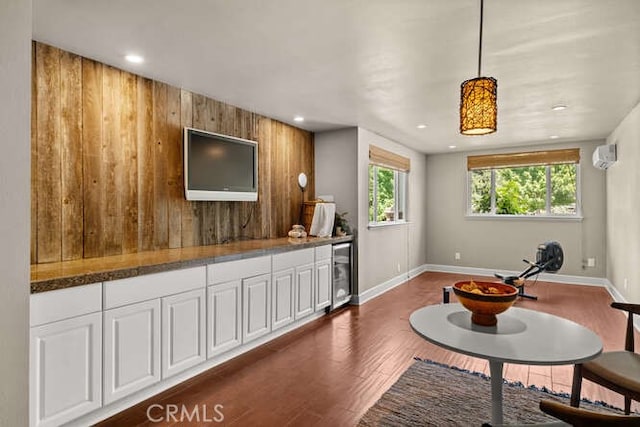 2915 Kennedy Ave Unit A & B, Chico, CA 95973 - living room featuring beverage cooler, dark wood-style floors, a wall unit AC, recessed lighting, and wooden walls