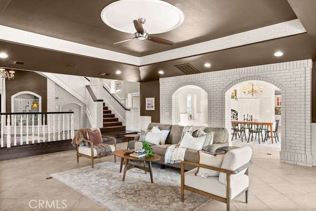 2915 Kennedy Ave Unit A & B, Chico, CA 95973 - living room with a chandelier, arched walkways, brick wall, ceiling fan, and tile patterned floors