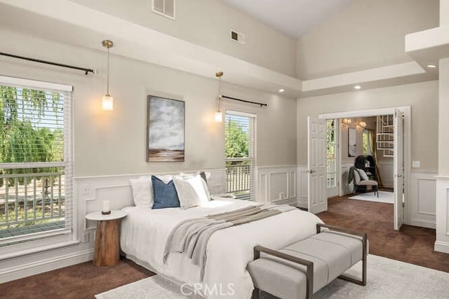 2915 Kennedy Ave Unit A & B, Chico, CA 95973 - carpeted bedroom with a decorative wall, multiple windows, wainscoting, and access to outside