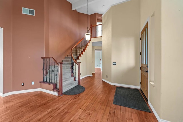1033 Goldeneye, Carlsbad, CA 92011 - foyer entrance with a high ceiling, light wood-style flooring, and stairs
