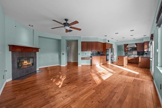 1033 Goldeneye, Carlsbad, CA 92011 - unfurnished living room with a ceiling fan, hardwood / wood-style floors, a tile fireplace, and recessed lighting