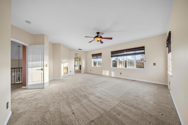 1033 Goldeneye, Carlsbad, CA 92011 - unfurnished living room with ceiling fan, carpet, and arched walkways