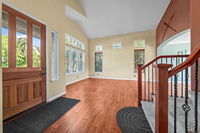 1033 Goldeneye, Carlsbad, CA 92011 - foyer with light wood-type flooring, stairs, and high vaulted ceiling