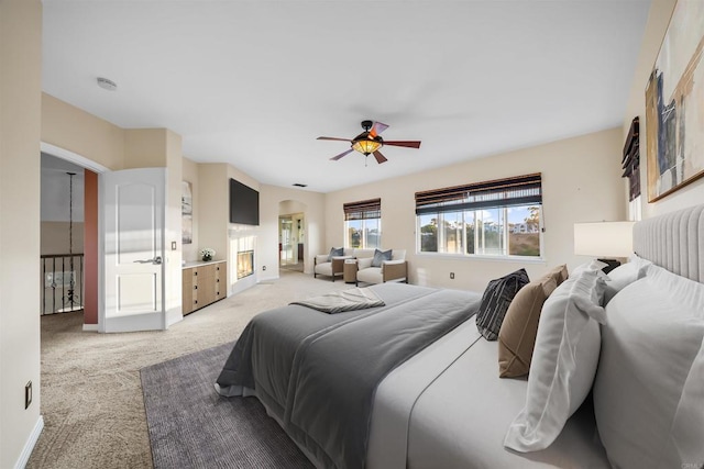 1033 Goldeneye, Carlsbad, CA 92011 - bedroom featuring light colored carpet, ceiling fan, and arched walkways