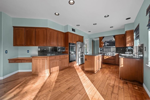 1033 Goldeneye, Carlsbad, CA 92011 - kitchen with stainless steel appliances, a kitchen island, backsplash, light wood finished floors, and recessed lighting