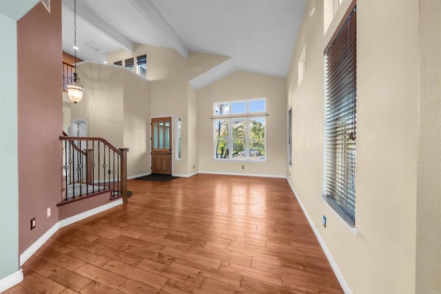 1033 Goldeneye, Carlsbad, CA 92011 - entryway featuring beamed ceiling, high vaulted ceiling, wood-type flooring, and stairs