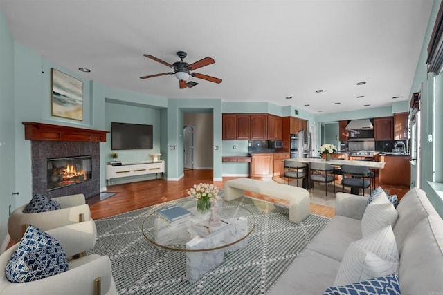 1033 Goldeneye, Carlsbad, CA 92011 - living area with wood finished floors, ceiling fan, and a tile fireplace
