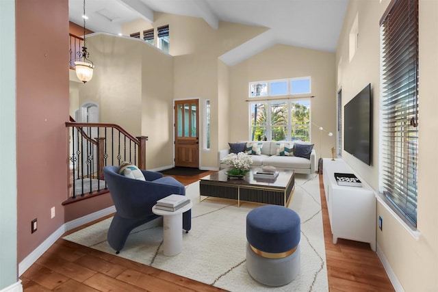 1033 Goldeneye, Carlsbad, CA 92011 - living area with high vaulted ceiling, wood finished floors, beam ceiling, and stairway