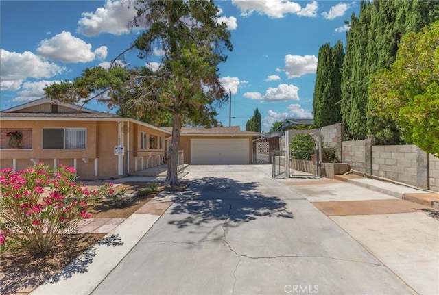 16257 Avalon Ave, Victorville, CA 92395 - ranch-style home with a garage, driveway, a gate, and stucco siding