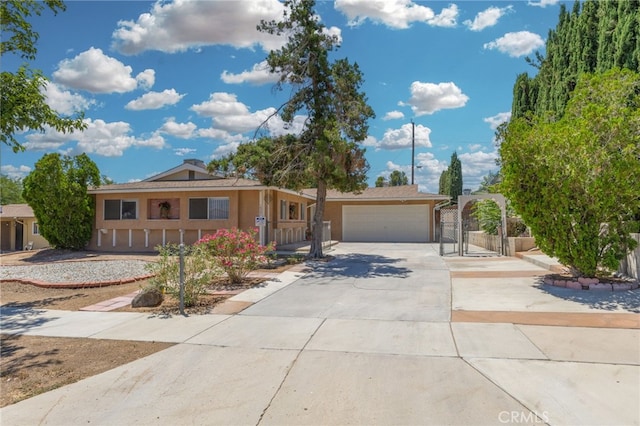 16257 Avalon Ave, Victorville, CA 92395 - view of front of property with driveway, a gate, a garage, and stucco siding