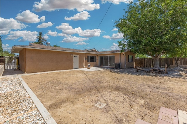 16257 Avalon Ave, Victorville, CA 92395 - rear view of house featuring stucco siding and a patio area