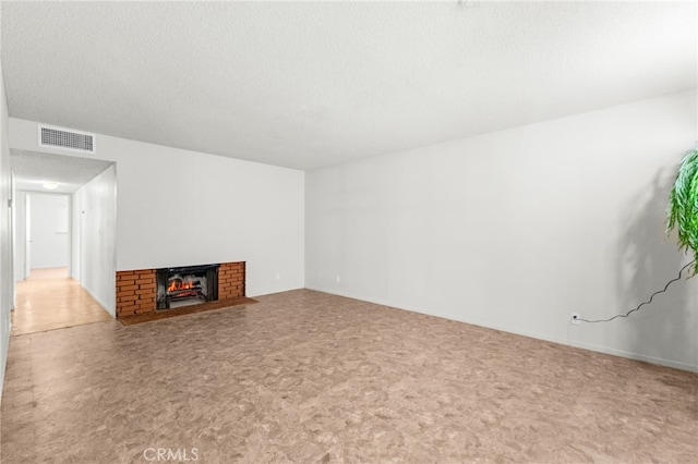16257 Avalon Ave, Victorville, CA 92395 - unfurnished living room featuring carpet floors, a brick fireplace, and a textured ceiling