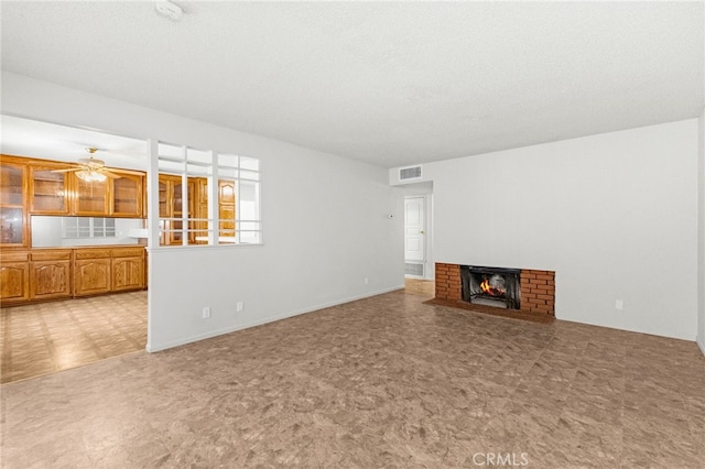 16257 Avalon Ave, Victorville, CA 92395 - unfurnished living room with a brick fireplace, a ceiling fan, and light floors
