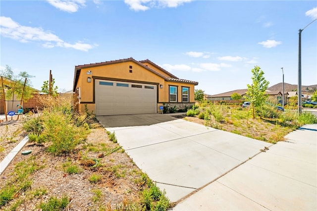 27108 Oncore Dr, Menifee, CA 92585 - view of front of property featuring stucco siding, a garage, driveway, and a tile roof