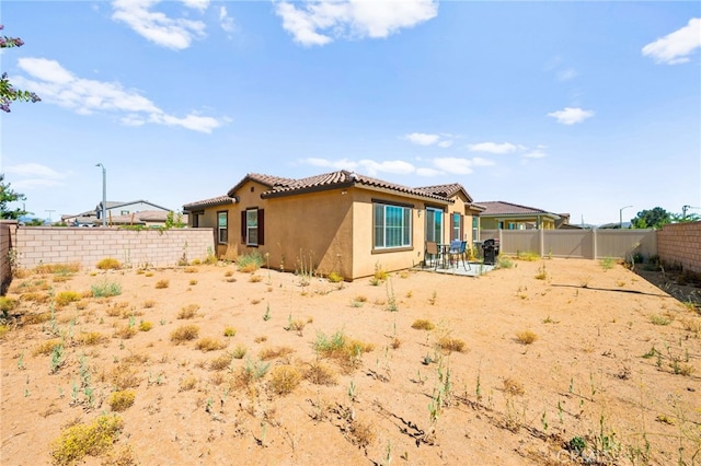 27108 Oncore Dr, Menifee, CA 92585 - rear view of property featuring stucco siding, a fenced backyard, and a patio