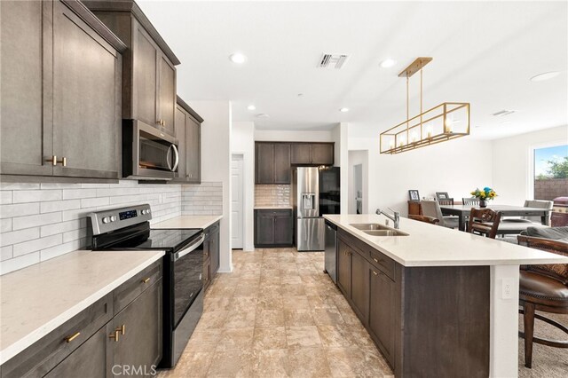 27108 Oncore Dr, Menifee, CA 92585 - kitchen with appliances with stainless steel finishes, backsplash, dark brown cabinets, a breakfast bar, and recessed lighting